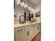 Bathroom featuring a double sink vanity with vanity lighting, framed mirrors and dark hardware at 1014 Starmoss Ln, Conyers, GA 30094