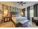Comfortable bedroom features an upholstered headboard, patterned wallpaper, and bright natural light at 1014 Starmoss Ln, Conyers, GA 30094