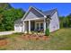 Charming single-Gathering home with a two-car garage, covered porch, and colorful landscaping at 1014 Starmoss Ln, Conyers, GA 30094