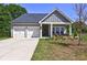 Charming single-Gathering home with a two-car garage, covered porch, and well-manicured lawn at 1014 Starmoss Ln, Conyers, GA 30094