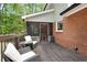 Outdoor deck showcasing a cozy seating area adjacent to brick exterior, creating an ideal space for outdoor gatherings at 125 Abner Dr, Mcdonough, GA 30252