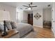 Bright bedroom featuring hardwood floors, a ceiling fan, and neutral paint at 125 Abner Dr, Mcdonough, GA 30252