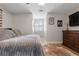 Cozy bedroom with wood floors, neutral walls, and modern decor at 125 Abner Dr, Mcdonough, GA 30252