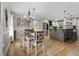 Dining room with modern chandelier and view of eat-in kitchen at 125 Abner Dr, Mcdonough, GA 30252