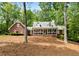 Attractive brick home featuring a cozy front porch in a serene, wooded setting at 125 Abner Dr, Mcdonough, GA 30252