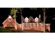 Charming brick home at night featuring a welcoming front porch with decorative wreaths at 125 Abner Dr, Mcdonough, GA 30252