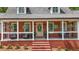 Inviting front porch with comfortable seating, hanging plants, and stylish decor at 125 Abner Dr, Mcdonough, GA 30252