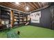 Basement golf simulator room with turf, screen, and Titleist decor for the avid golfer at 125 Abner Dr, Mcdonough, GA 30252