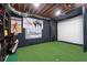 Basement golf simulator room with turf, screen, and Titleist decor for the avid golfer at 125 Abner Dr, Mcdonough, GA 30252