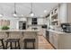 Eat-in kitchen featuring stainless steel appliances, stone countertops, light colored cabinets, and stylish pendant lighting at 125 Abner Dr, Mcdonough, GA 30252