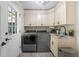 Laundry room featuring washer and dryer, sink, stone countertop, and door to exterior at 125 Abner Dr, Mcdonough, GA 30252