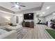 Beautiful living room with hardwood floors, television, exercise area and ample seating at 125 Abner Dr, Mcdonough, GA 30252