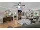 Cozy living room features a fireplace, hardwood floors, ceiling fan, and lots of natural light at 125 Abner Dr, Mcdonough, GA 30252