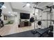 Recreation room featuring exercise equipment, television and golf simulator for entertainment and fitness at 125 Abner Dr, Mcdonough, GA 30252