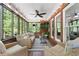 Relaxing screened porch features comfortable seating and views of the backyard at 125 Abner Dr, Mcdonough, GA 30252
