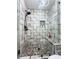 Bathroom featuring a tiled walk-in shower with a glass enclosure and built-in niche at 125 Abner Dr, Mcdonough, GA 30252