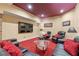 Finished basement featuring red carpet, black leather couches, and large screen television at 2220 Peachtree Rd, Cumming, GA 30041
