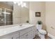 Bathroom featuring shower, single vanity, and views to a plant at 2220 Peachtree Rd, Cumming, GA 30041