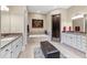 Spa-like bathroom with a soaking tub, walk-in shower, and dual vanities at 2220 Peachtree Rd, Cumming, GA 30041