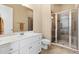 Bathroom featuring white cabinets, a walk-in shower, and neutral tile flooring at 2220 Peachtree Rd, Cumming, GA 30041