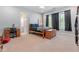 Bedroom with four-poster bed, desk and chair with view to en-suite bathroom at 2220 Peachtree Rd, Cumming, GA 30041