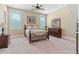 Comfortable bedroom with neutral carpet, large windows, and traditional furnishings at 2220 Peachtree Rd, Cumming, GA 30041
