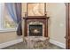 Close-up of a stone fireplace with a wooden mantle and decorative candles at 2220 Peachtree Rd, Cumming, GA 30041