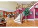 Grand foyer featuring a curved staircase, wood floors, and high ceilings at 2220 Peachtree Rd, Cumming, GA 30041