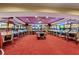 Spacious game room featuring multiple pinball machines, game tables, and red carpeting at 2220 Peachtree Rd, Cumming, GA 30041