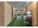 Extended garage with metal ceiling, brick accents, and storage shelves with outdoor vehicle at 2220 Peachtree Rd, Cumming, GA 30041