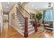 Hallway featuring hardwood floors and wood stairs at 2220 Peachtree Rd, Cumming, GA 30041