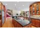 Spacious kitchen with island cooktop and adjacent living and dining areas at 2220 Peachtree Rd, Cumming, GA 30041