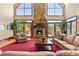 Inviting living room features a soaring stone fireplace, large windows, and comfortable seating at 2220 Peachtree Rd, Cumming, GA 30041