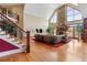Bright living room showcasing soaring ceilings, stone fireplace, and sliding doors to the exterior at 2220 Peachtree Rd, Cumming, GA 30041