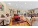 Cozy living room featuring a red and tan color scheme, hardwood floors, and large windows at 2220 Peachtree Rd, Cumming, GA 30041