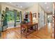 Well-lit home office with hardwood floors, a desk, and a large window with a view at 2220 Peachtree Rd, Cumming, GA 30041