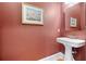 Classic powder room with pedestal sink and decorative mirror at 2220 Peachtree Rd, Cumming, GA 30041