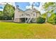 Large backyard with lush green grass and a deck connected to the home's upper level at 3233 Bagley Psge, Duluth, GA 30097