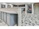 Open basement area with tiled floor, columns, gray cabinets and decorative stone half-wall at 3233 Bagley Psge, Duluth, GA 30097