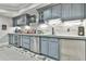 Basement bar with gray cabinets, stone backsplash, stainless appliances and a drink fridge at 3233 Bagley Psge, Duluth, GA 30097