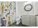 Stylish bathroom features a shower with fun shower curtain, round mirror, and modern vanity at 3233 Bagley Psge, Duluth, GA 30097