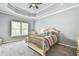 Cozy bedroom with neutral tones, carpet, ceiling fan, and a large window at 3233 Bagley Psge, Duluth, GA 30097