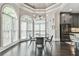 Bright breakfast nook with a round glass table and large windows providing ample natural light and dark hardwood floors at 3233 Bagley Psge, Duluth, GA 30097