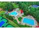 Aerial view featuring community pools, a water park, tennis courts, and lush landscaping at 3233 Bagley Psge, Duluth, GA 30097