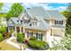 Stunning two-story home boasting a manicured lawn, beautiful landscaping and a charming covered entryway at 3233 Bagley Psge, Duluth, GA 30097
