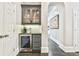 View of hallway with a wine cooler and mini bar area, hardwood floors, and white trim at 3233 Bagley Psge, Duluth, GA 30097