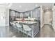 Gourmet kitchen with a large center island, breakfast bar, and modern stainless steel appliances at 3233 Bagley Psge, Duluth, GA 30097