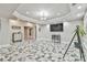 Spacious living room area with unique tile flooring, recessed lighting, and large TV at 3233 Bagley Psge, Duluth, GA 30097