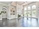 Spacious living room with floor-to-ceiling windows, fireplace, and stylish built-in shelving at 3233 Bagley Psge, Duluth, GA 30097