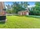 Spacious backyard featuring well maintained lawn and a detached garage at 1272 Saxony Se Dr, Conyers, GA 30013
